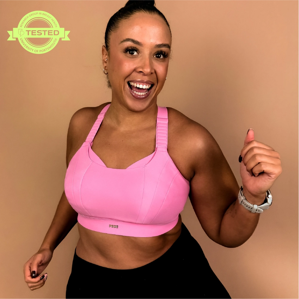 Model wearing supportive high impact sports bra suitable for running and high intensity exercise.