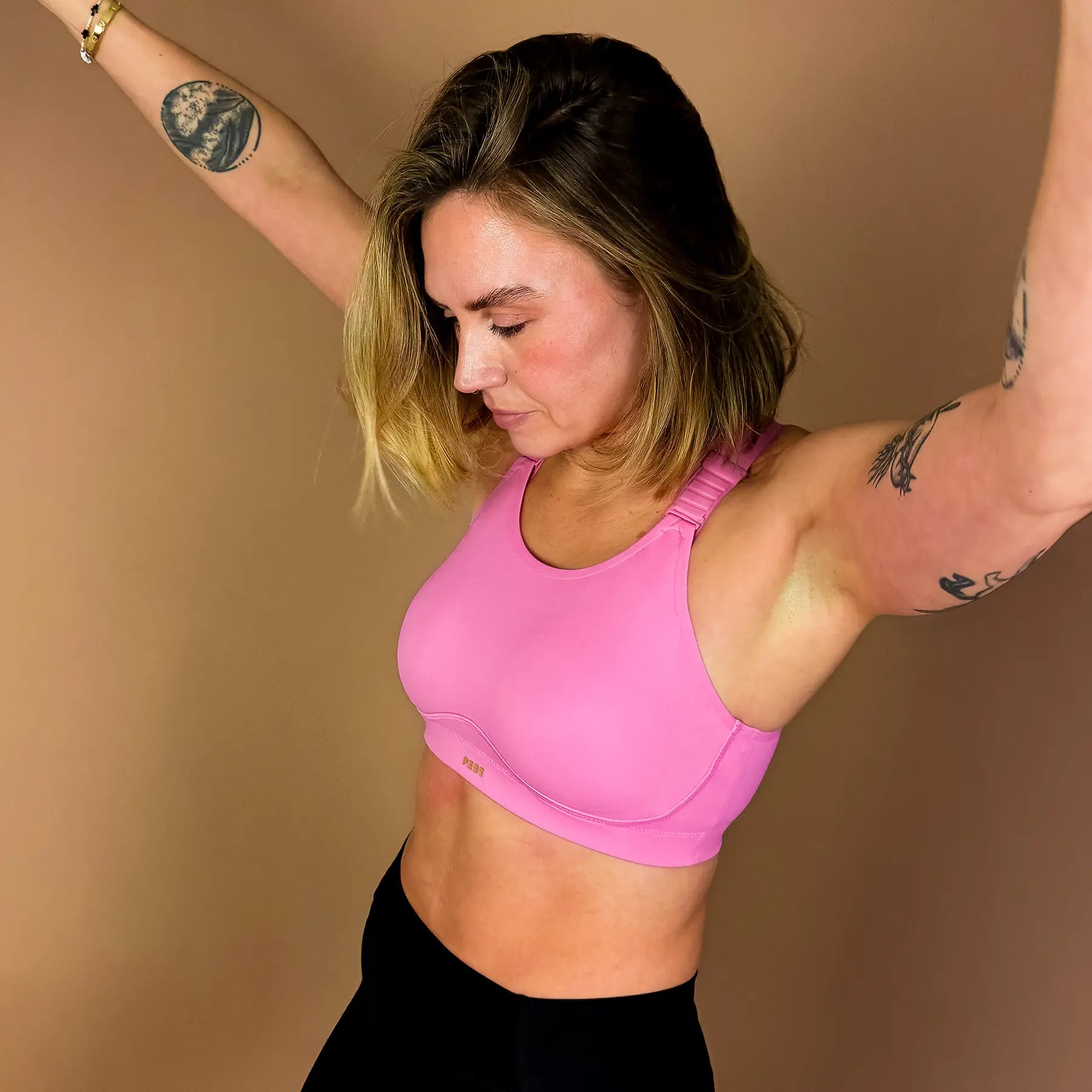 Woman wearing PEBE Cloud pink sports bra designed for gym workouts, showing soft support and comfortable fit.