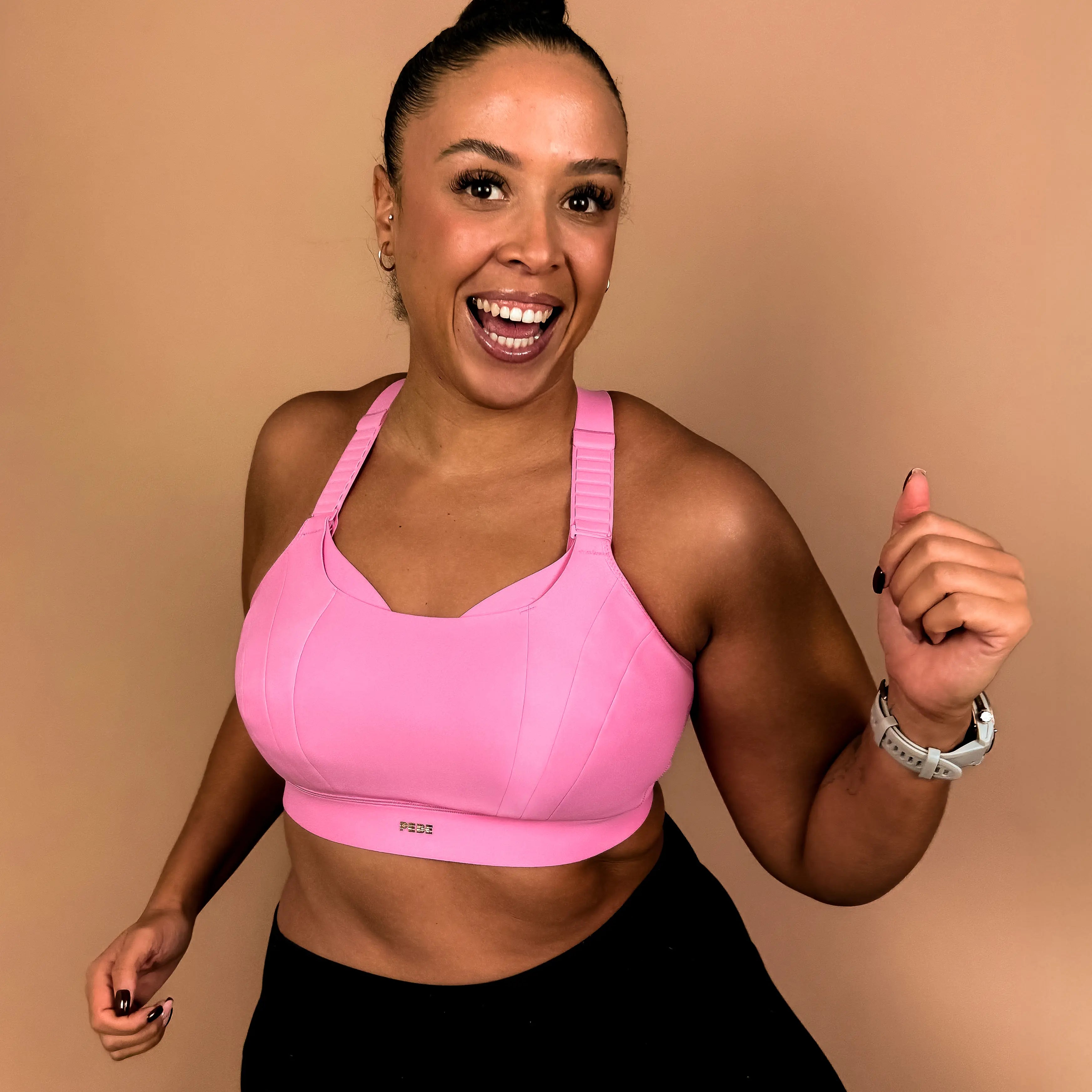 Model wearing supportive high impact sports bra suitable for running and high intensity exercise.