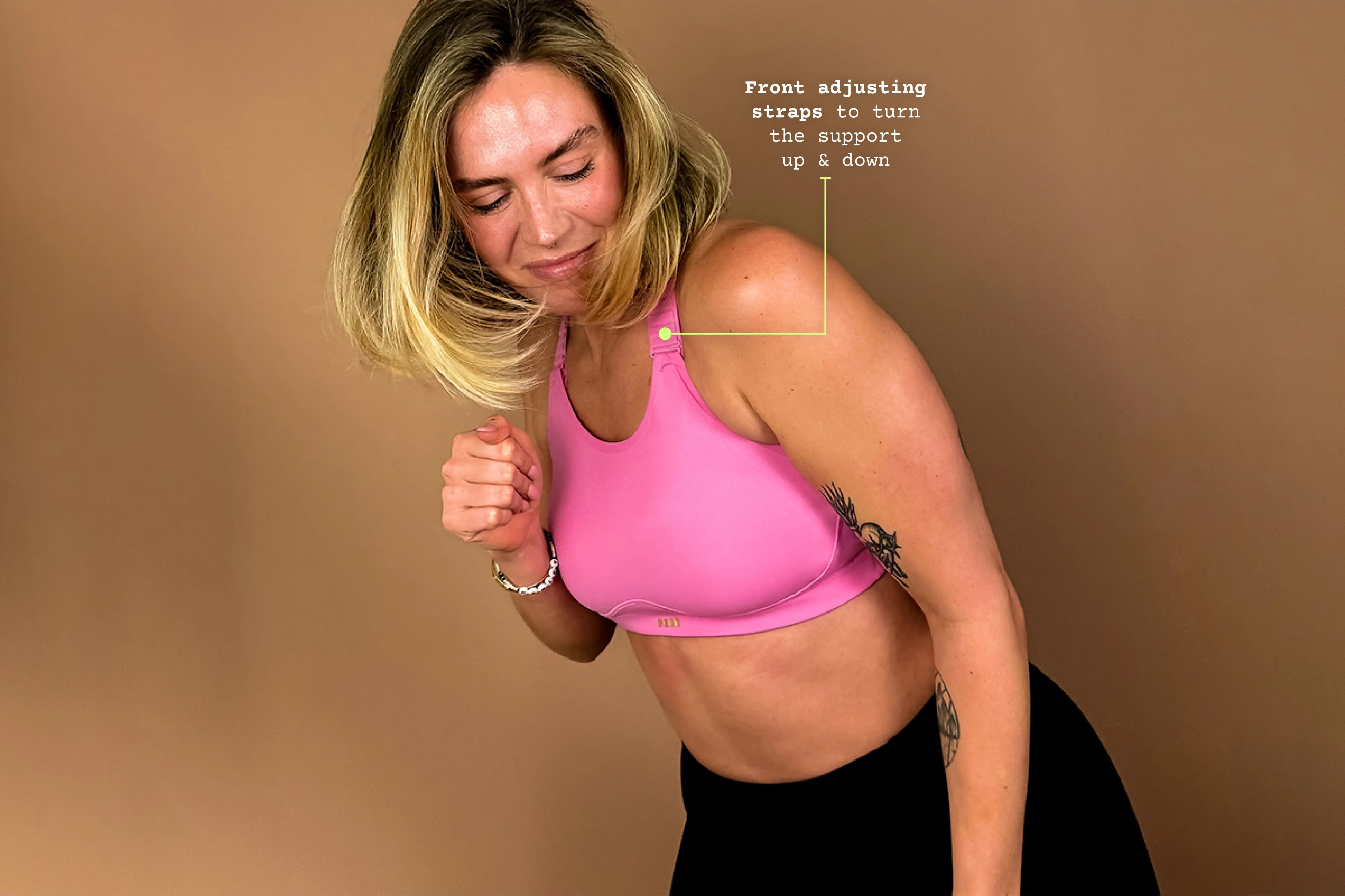 Model wearing pink Cloud sports bra showing adjustable front straps during movement.