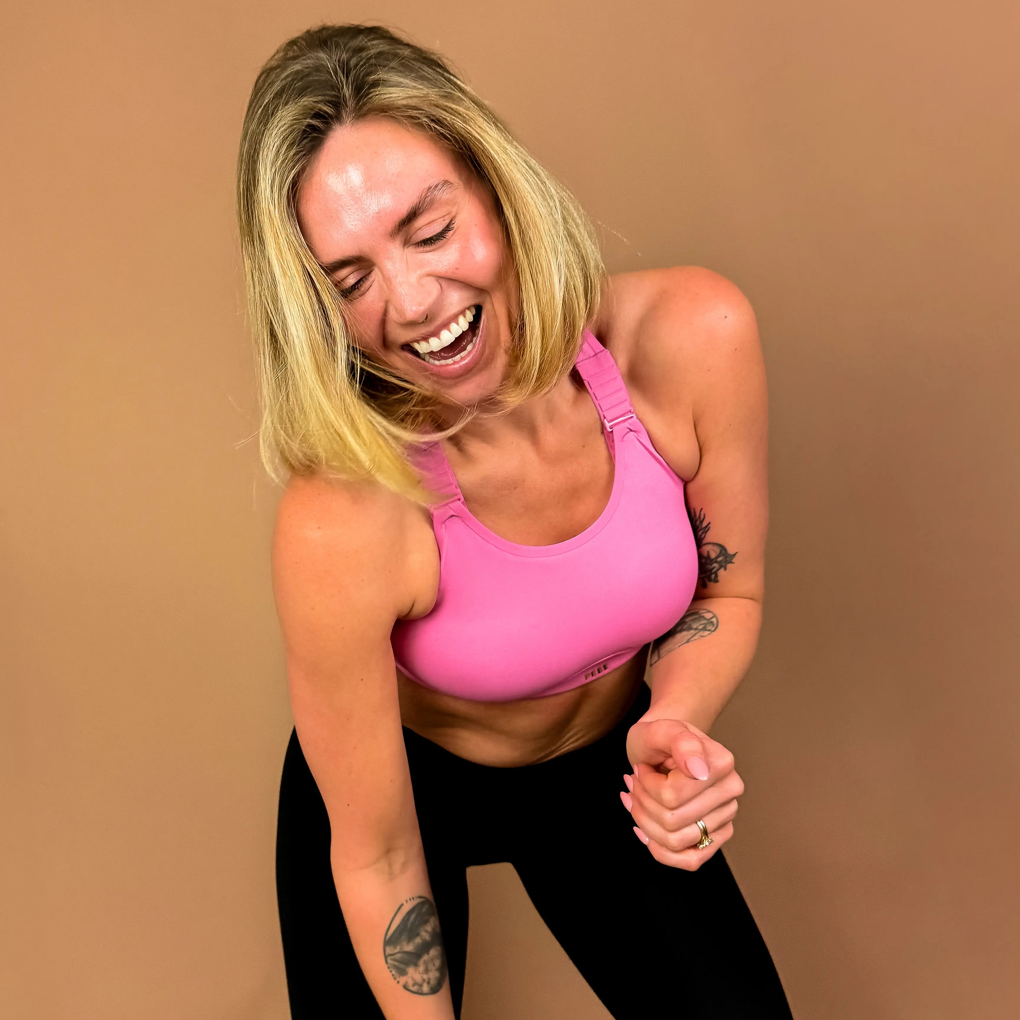Model wearing Cloud sports bra during gym-style movement, designed for comfort and ease of movement.