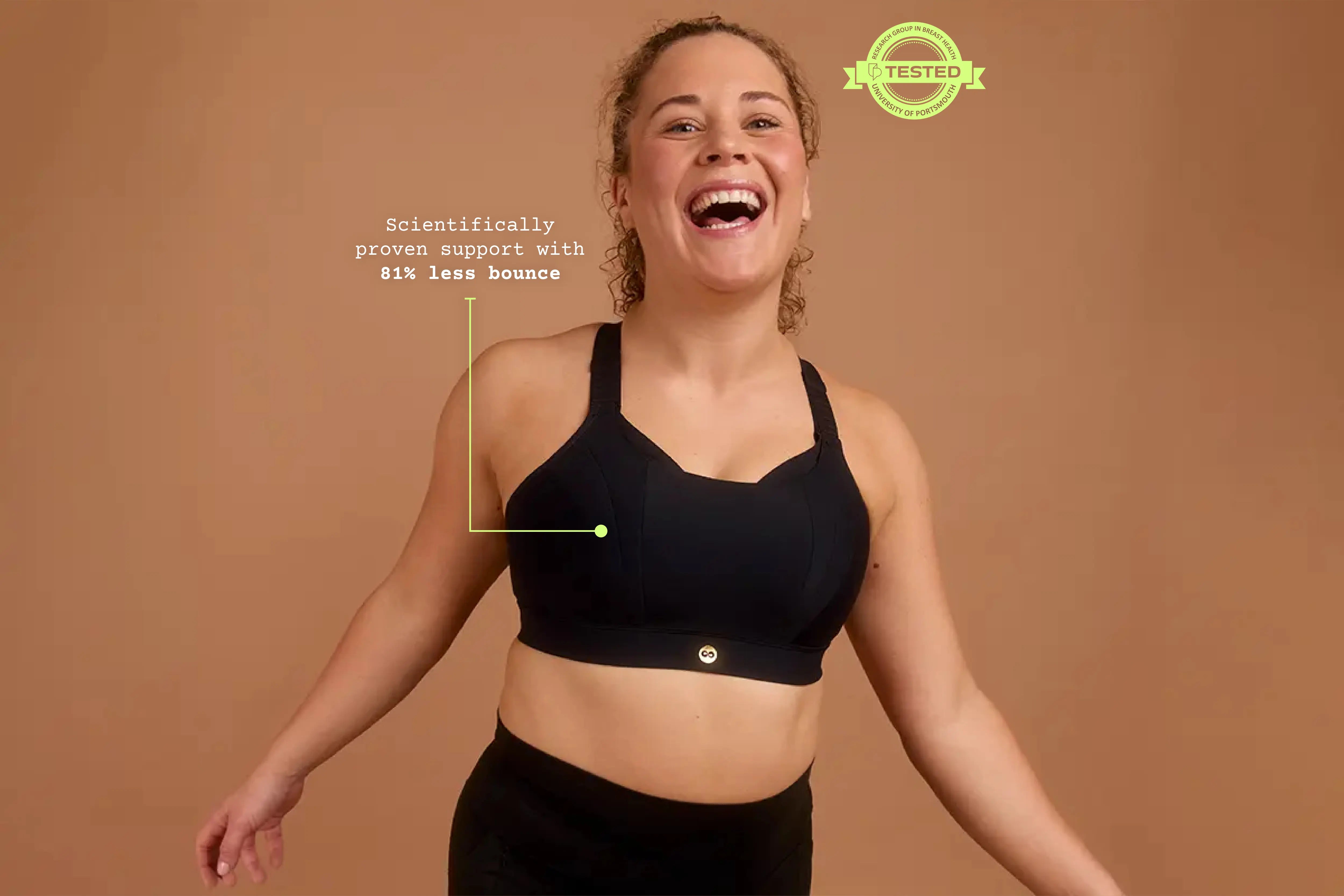 Front view of model wearing black Gravity high impact sports bra with structured support.