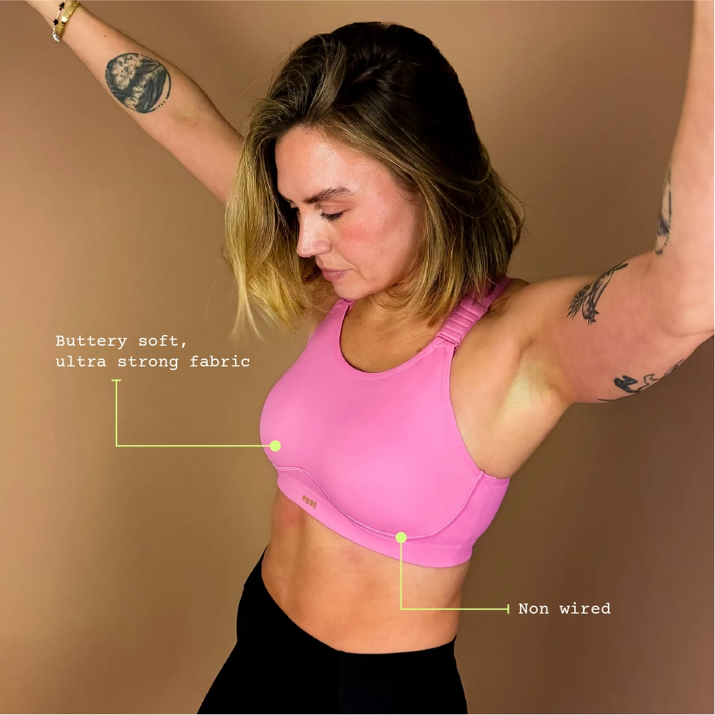 Woman wearing PEBE Cloud pink sports bra designed for gym workouts, showing soft support and comfortable fit.