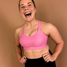 Pink high impact sports bra providing strong support for running and gym workouts.
