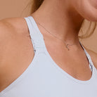 Close-up of strap detail on light blue adjustable sports bra
