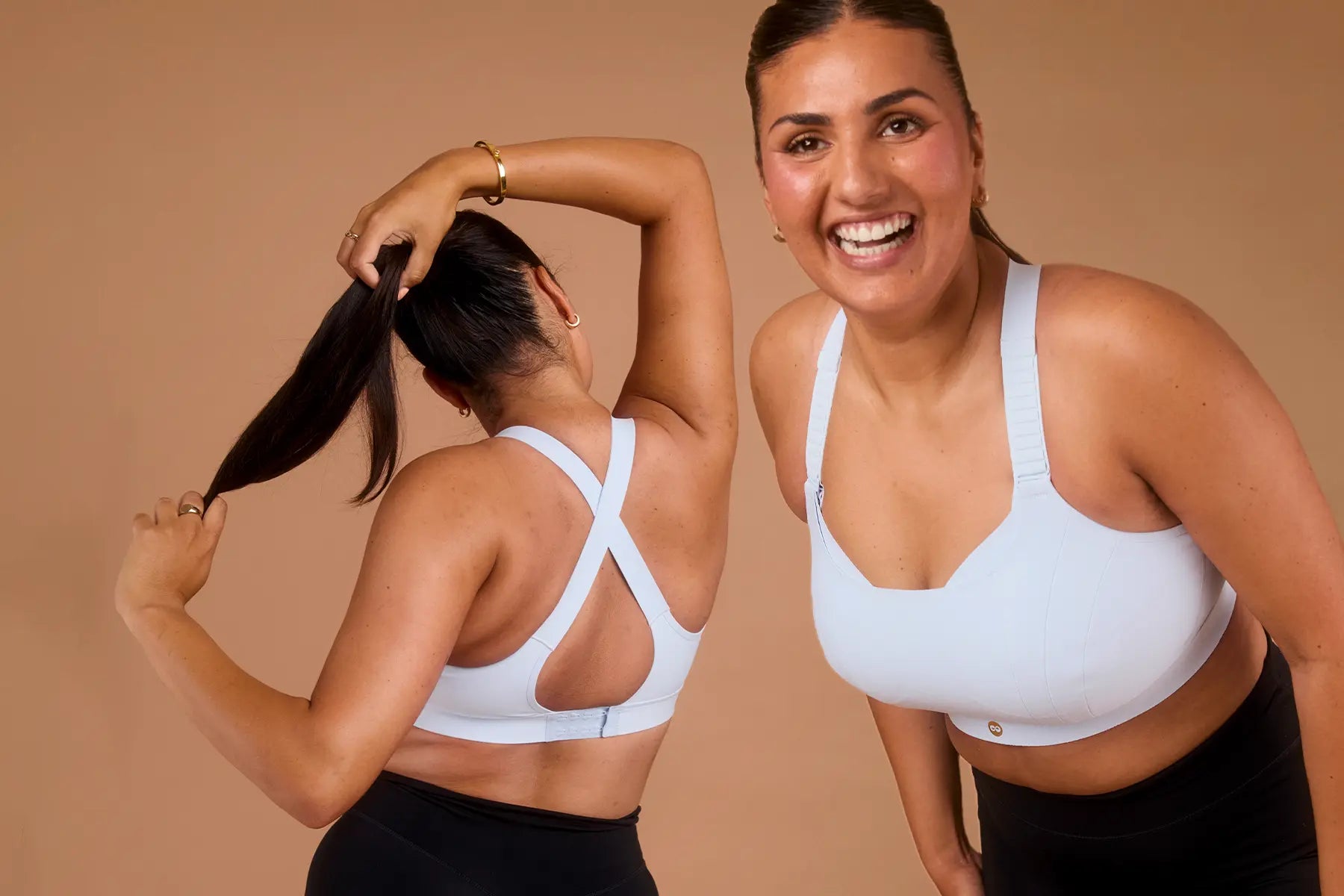 Woman wearing blue sports bra shown from front and back with crossover back straps.