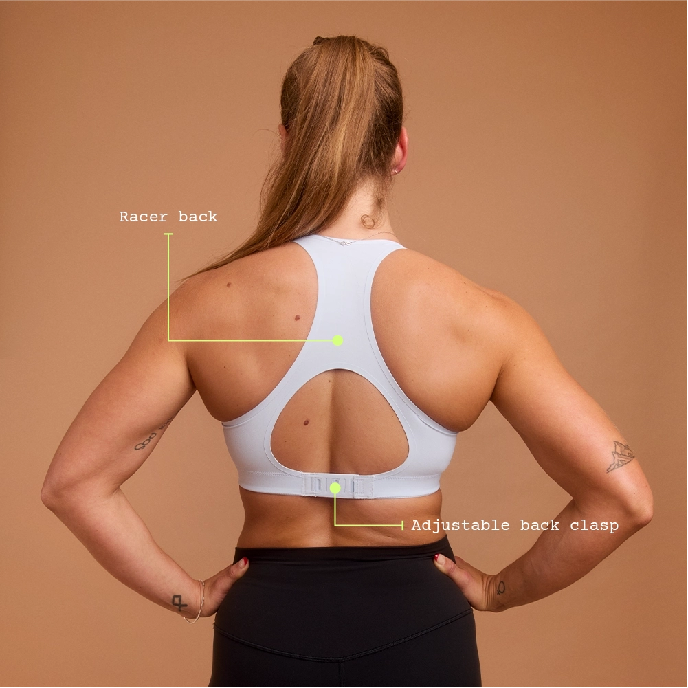 Back view of woman in light blue racerback sports bra with clasp closure